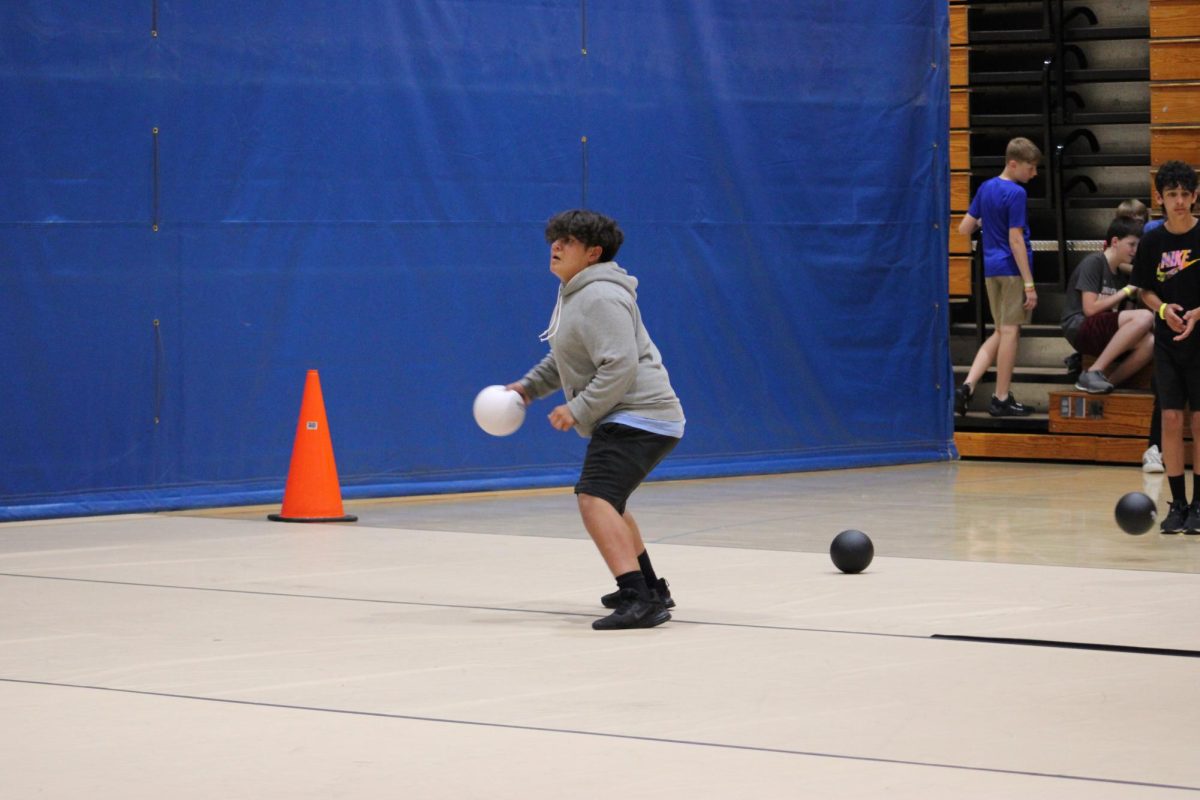  During the dodgeball tournament on May 17th in Gym A, 7th grader Adrian Vargas gets ready to throw a ball at his opposing team to get them out. “I decided to do dodgeball because I’ve always liked dodgeball,” Vargas said. 

