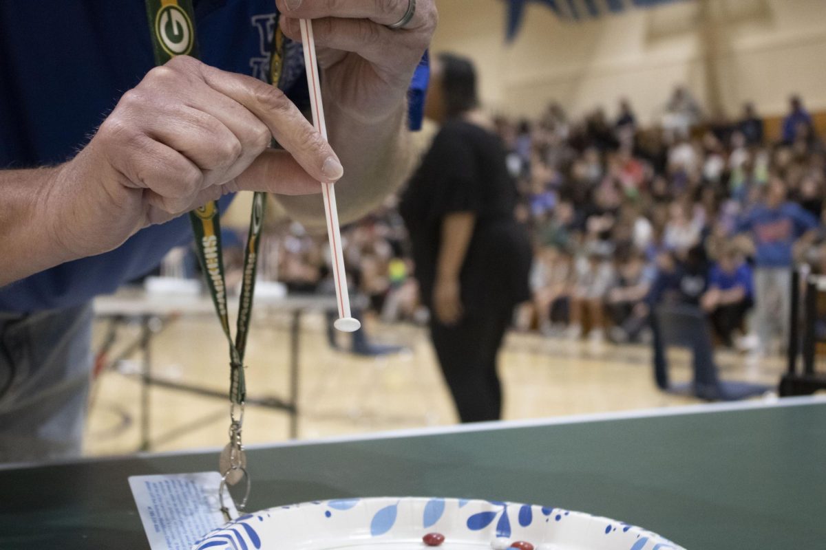 During 8th grade FAST on April 10th, 8th grade Champions Math Teacher Mr. Dillion picks up M&Ms with a straw in the Minute to Win it game Suck it Up against 8th grader Ava Kuhlman.
