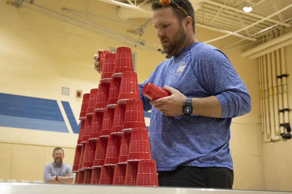Heat team’s Mr. Weese stacks cups on April 10th during 8th grade Minute to Win It game against 8th grader Audrey Threadgold. “Honestly, I just chose the first face I saw because didnt know that I had to pick names,” Weese said.
