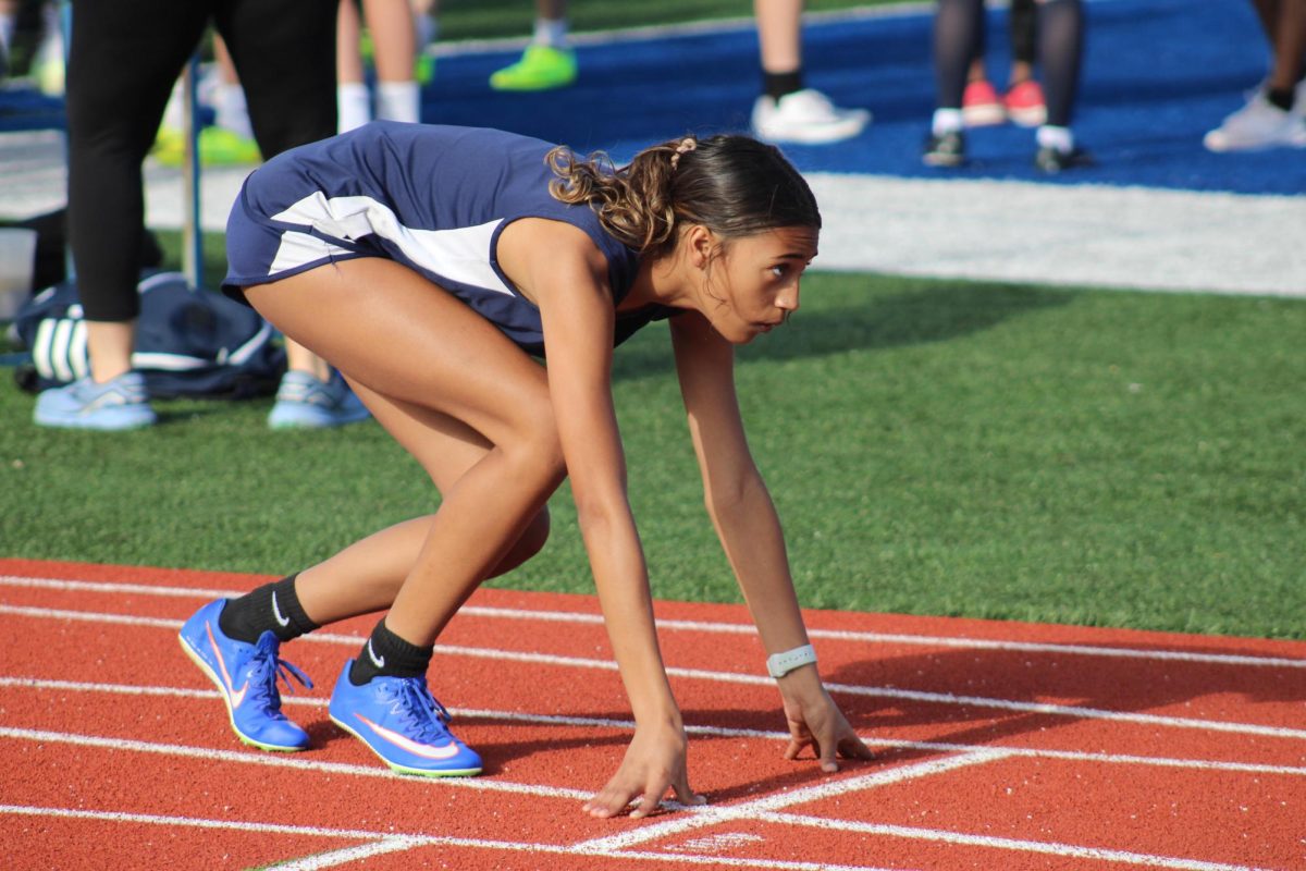 Chloe Richard, a 7th grade track athlete lines up for the 100m. Richard is doing the 100m, 200m, and some relays this track season. Richard said, “I chose to do track to stay in shape for wrestling.” 
