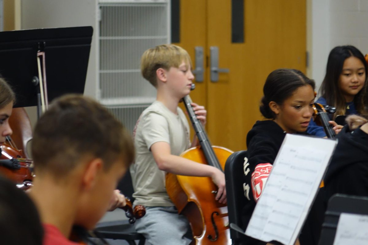 On Oct. 3, 8th graders Owen White, Amaya Lewis, Aliyah Tangpricha, and Logan Decker play their instruments in the WRMS orchestra room, while practicing for their concert.