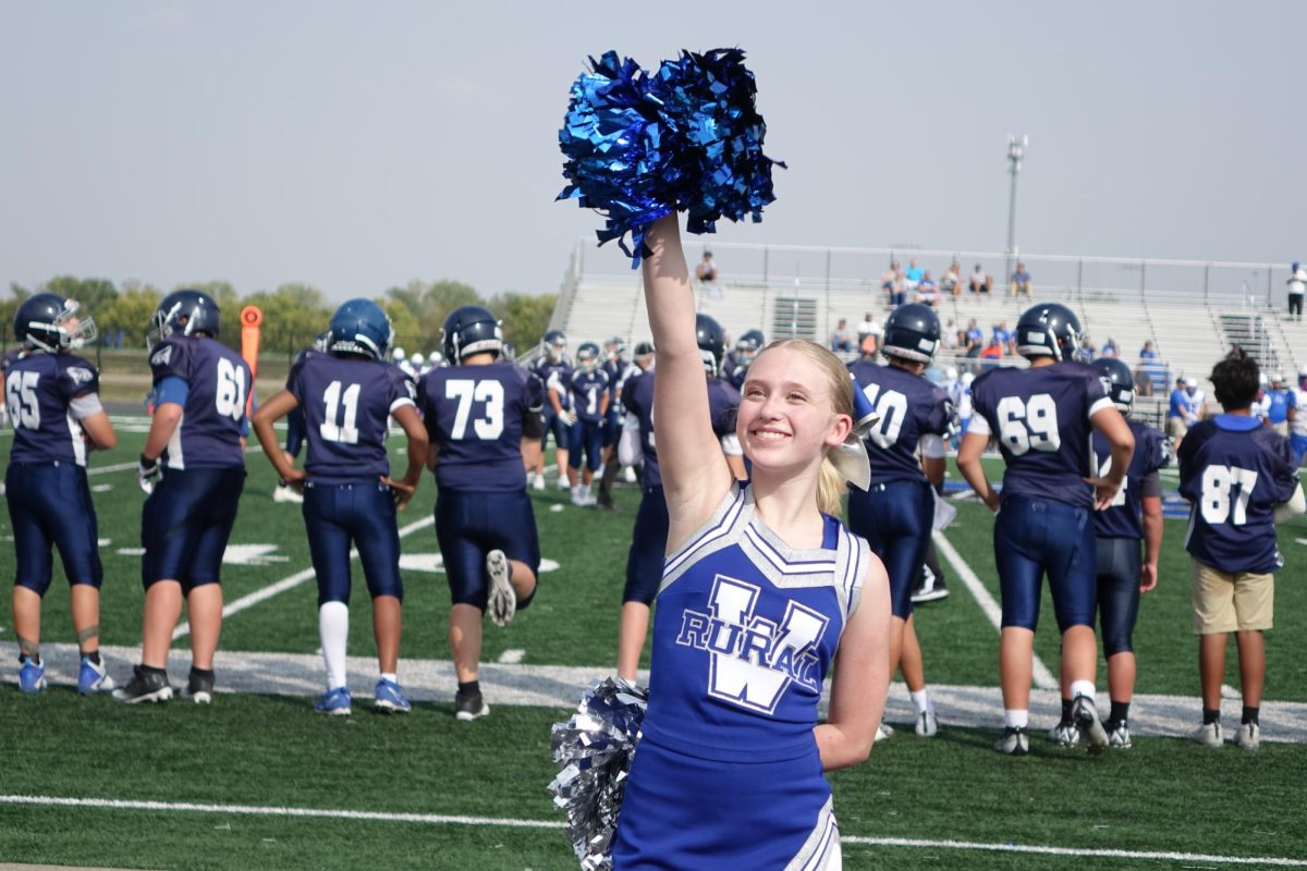 8th grader, Kylin Buchman, cheers from the sidelines to hype up the student section at the WRMS football game against Junction City on Sept. 12.