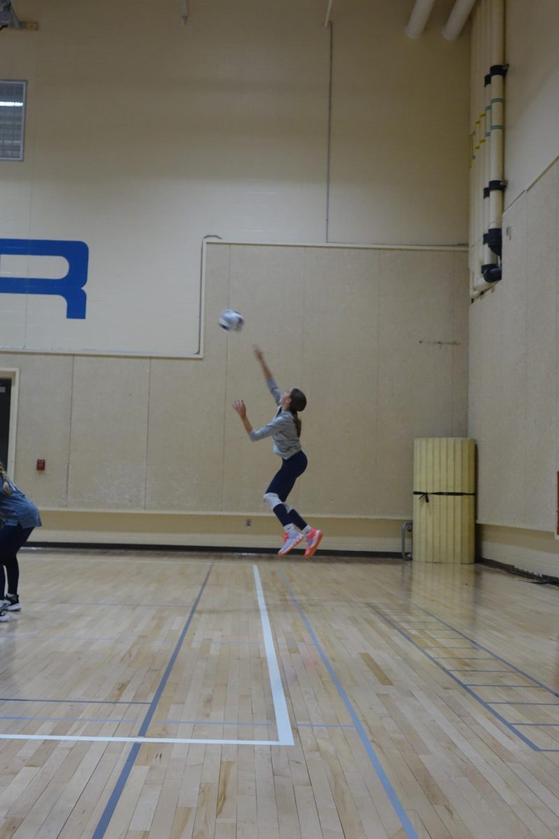 8th grade volleyball player Kinley Frost serves the ball to the opposing team, during a match against Emporia Middle School at WRMS on September 12.