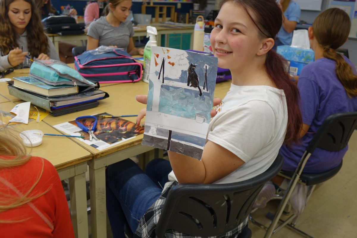 On Sept. 18, Madison Johnson makes a collage using magazine pieces for color and texture, to show understanding of realistic color in her 8th grade art class. Johnson created her piece to look like the inside of a cat cafe, looking out to the blue sky.
