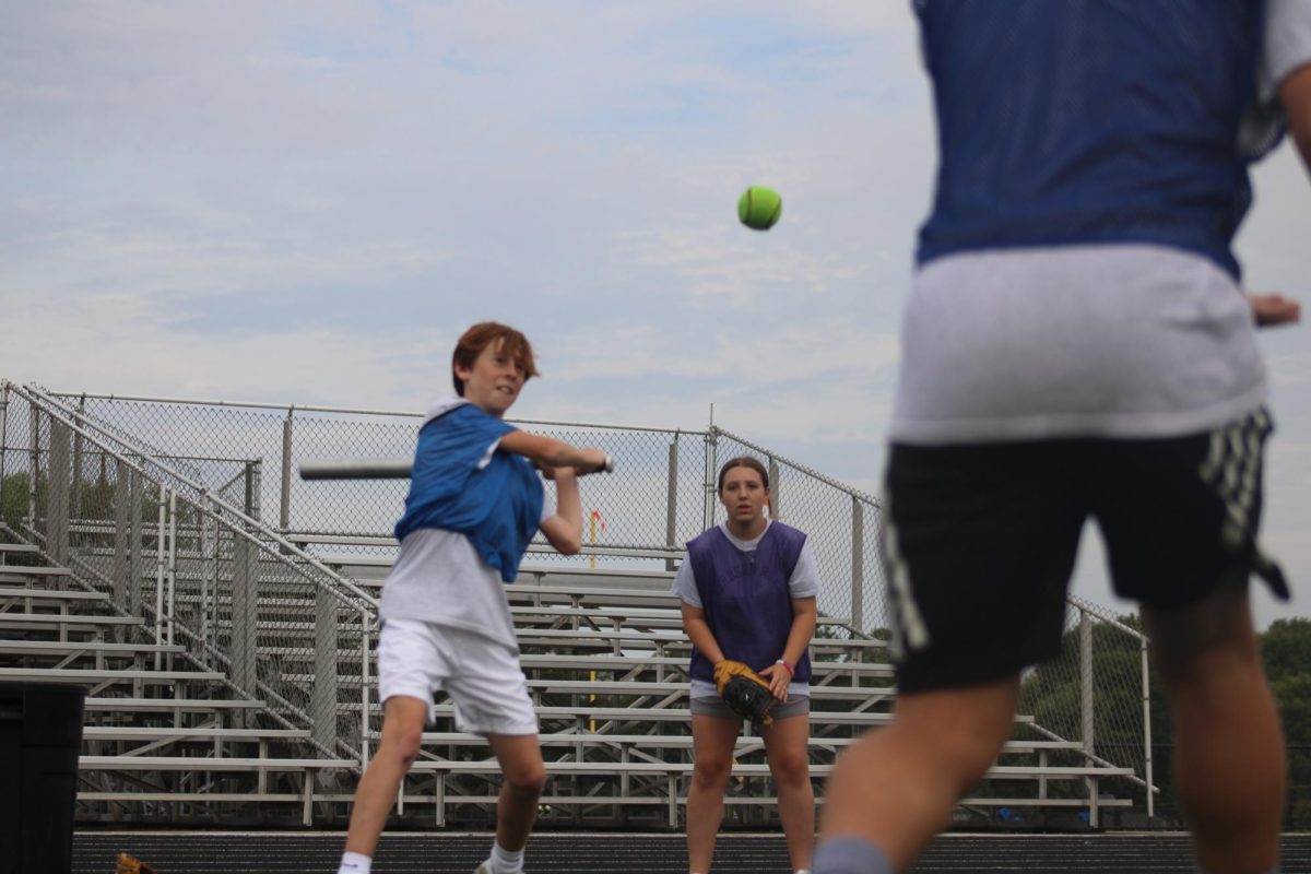 On Sept.18, on the WRMS football field, Isaiah Sexton hits the ball to get on base, while Raeya Brecheisen waits in back to catch the ball, during their softball unit in PE.