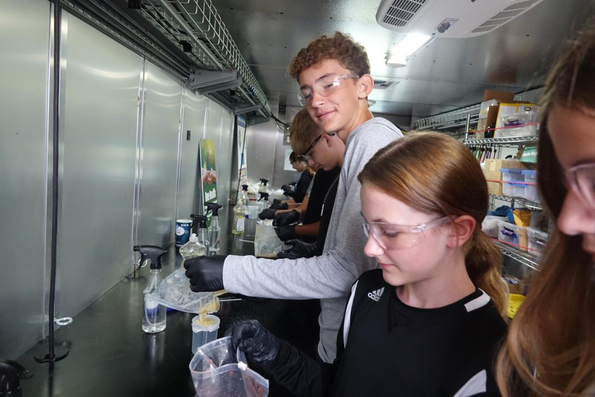 On September 13 outside of WRMS 7th graders  Jake Holmstedt, Mariner Svaty, Addy Parish, and Teagan Cook work with bananas and strawberries for Voyager Lab. 
