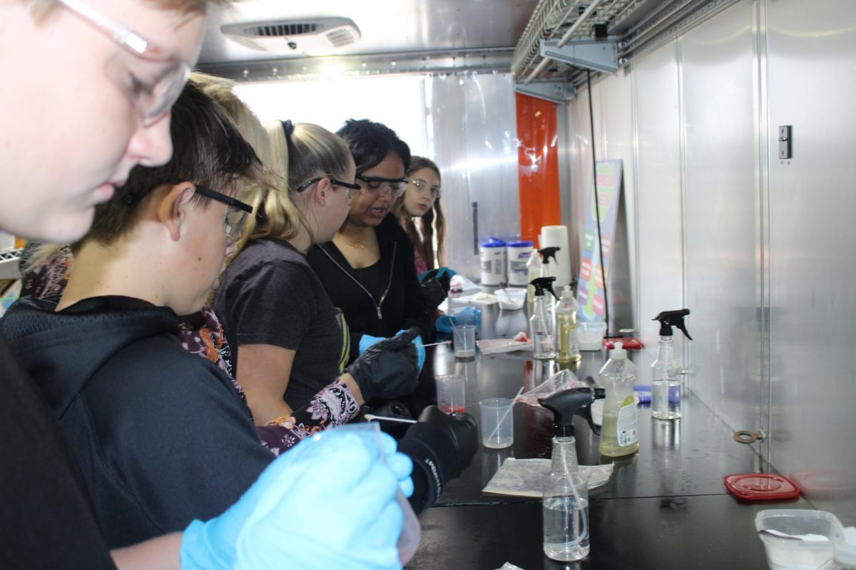 On Sept. 24, 7th graders Zander Adolf, Conner Wasson, Caylee Cazier, Aleigha Collins, and Felecity Preissner extract DNA from strawberries for science class in the KDHE traveling lab.
