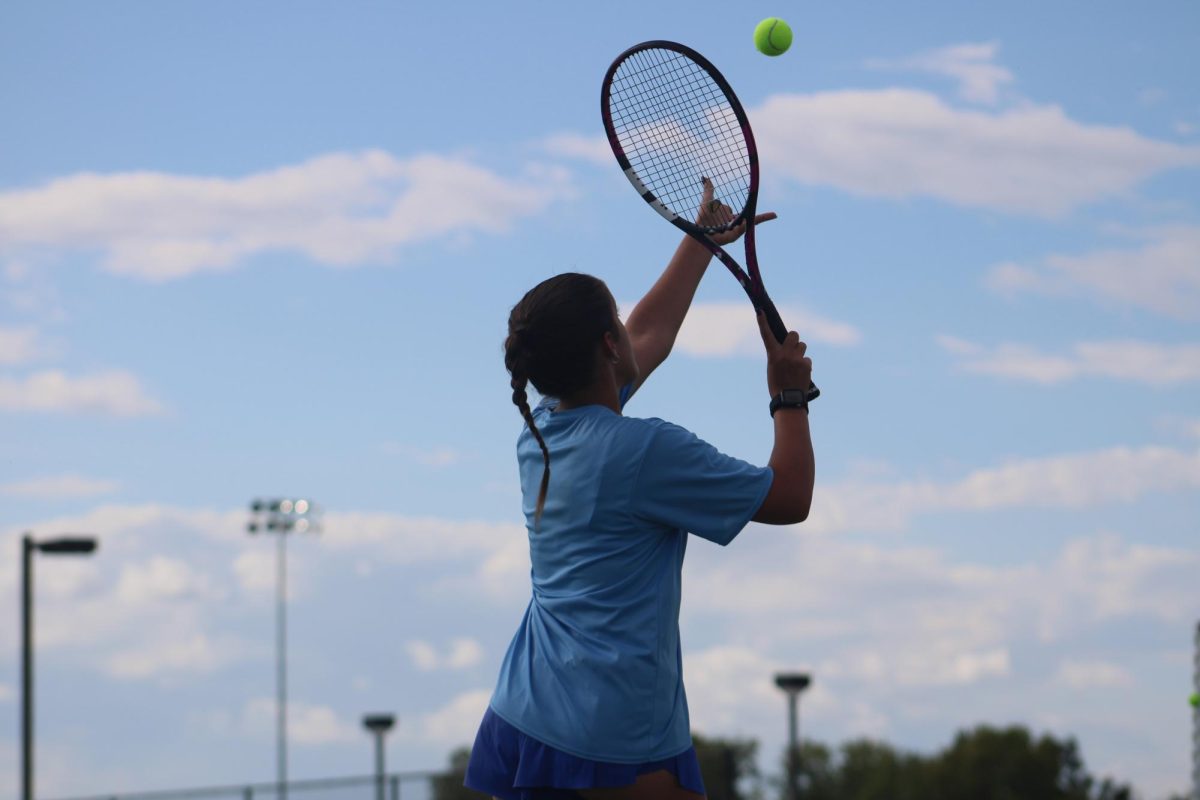 On Sept. 24 at WRMS, 8th grade tennis player, Corah Sholar, serves the ball to her opponent to start the match.