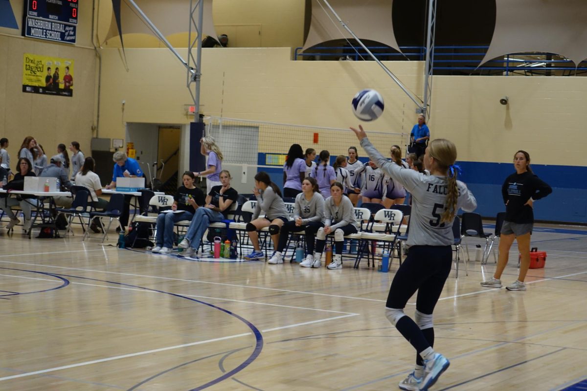 8th grader Quinn Nolte, serves the ball to the opposing team, on Sept. 26 at the WRMS volleyball match against Manhattan-Anthony.