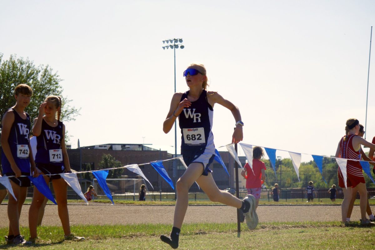 On Sept 26 at WRMS, Avery Kennedy runs her second mile of the course without her 
left shoe. Kennedy’s shoe fell off at the one mile mark during the race.
