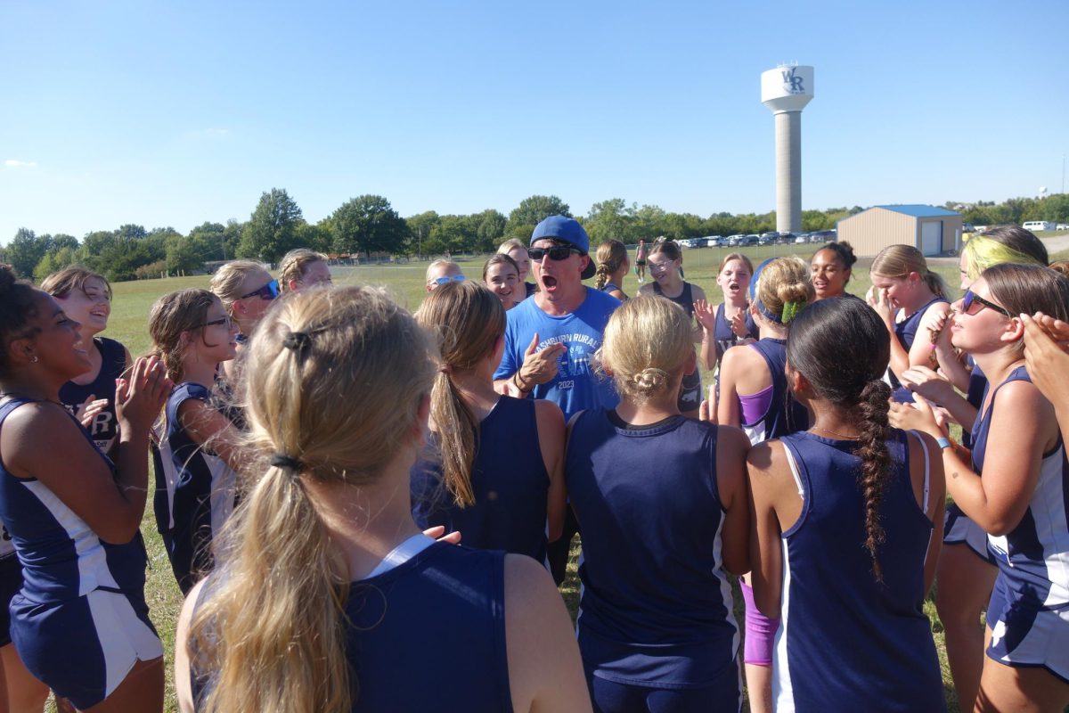 On August 26 at WRMS, Coach Brown hypes up the 7th grade girls cross country team by chanting to get them excited for their race.