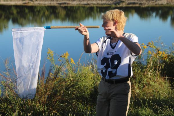 7th grader Colin Daniel catches a grasshopper at WRMS on Sept 26. as part of his search for butterflies in Mrs. Campbell's second hour class.