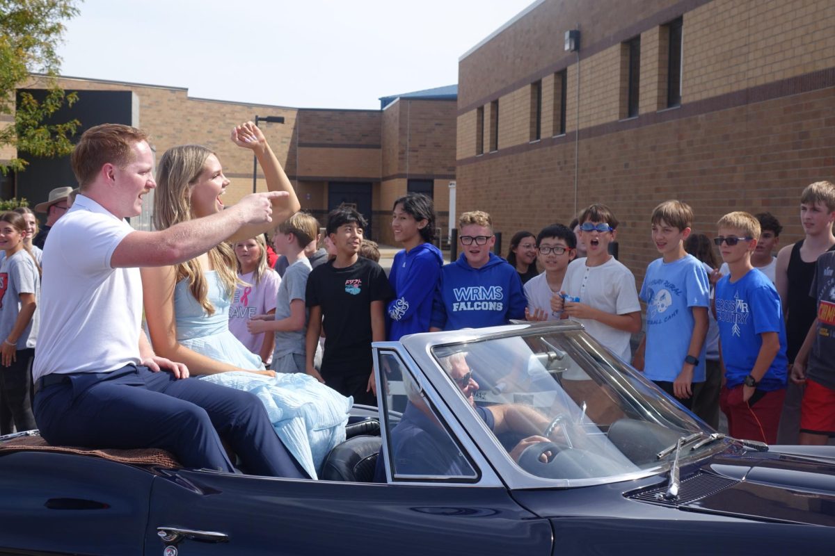 8th grade students cheer on the WRHS Homecoming Court candidates as they drive by at the homecoming parade on Sept. 27.

