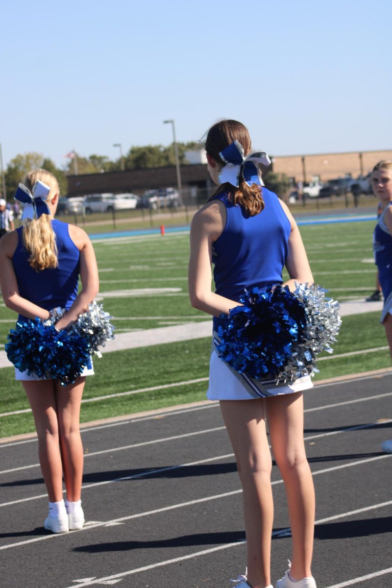 On Oct. 3, Abby Calvert, Reese Elliott, and Abi McGuire watch the football game at WRMS. Eighth grade cheerleader, Abby Calvert says, “I did cheer again this year because it was fun and I liked meeting new friends.” 