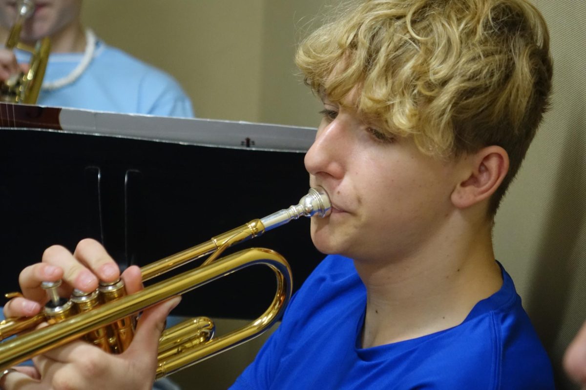 On Nov. 12, Mathew Conran plays his trumpet during band class in the  practice rooms.
