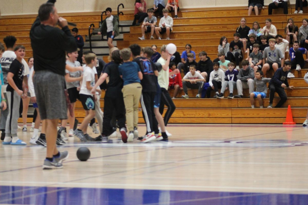 During the 7th grade dodgeball game,Mr.Garland announces the winning team so this 7th grade team is cheering after they just won the dodgeball round because they got more people out more than the other team on November 12.