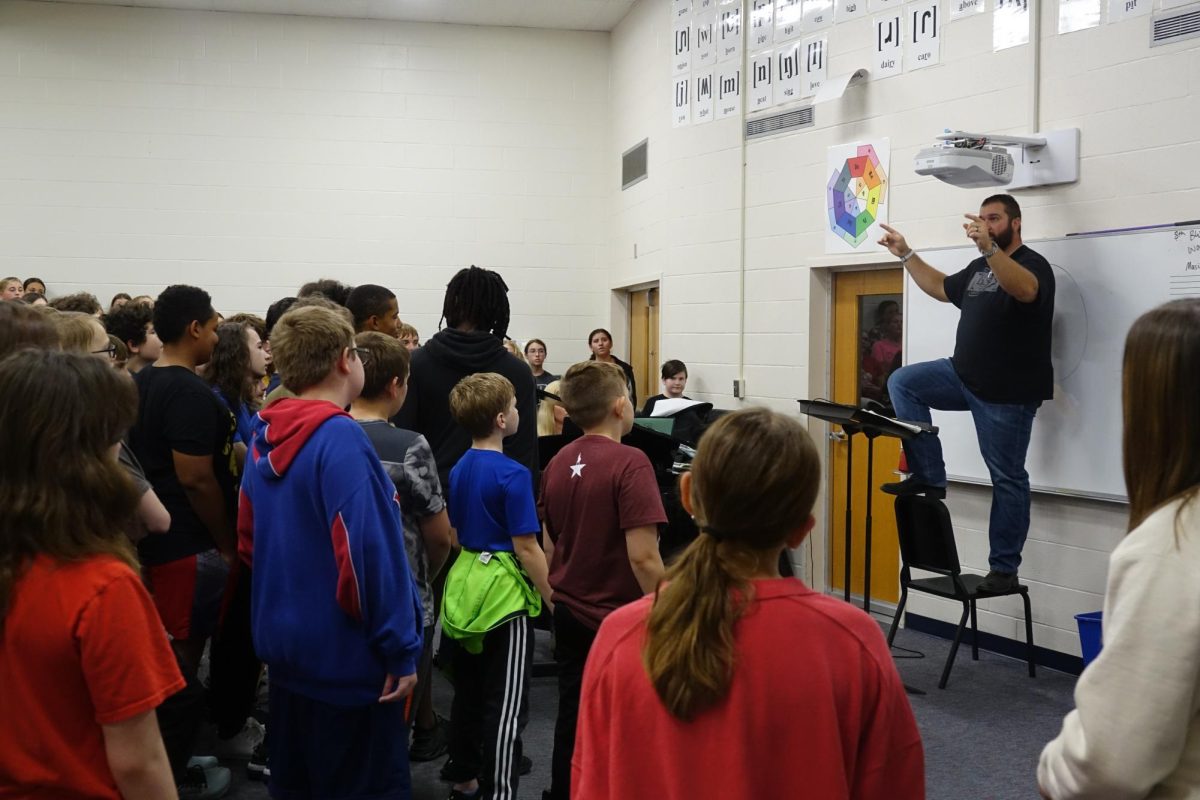 On Nov. 4, Mr. Lambotte teaches the 7th grade choir during one of the mass rehearsals.