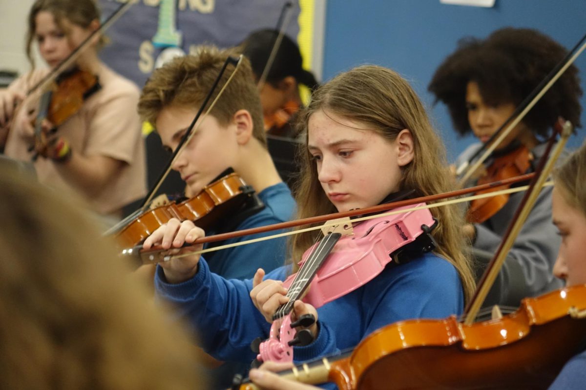 On Nov. 5, 7th grader Felecity Preissner plays her pink violin at the orchestra rehearsal. Preissner got her pink violin after she broke her other violin, “I broke my other violin and I needed to buy another one and I like pink”.
