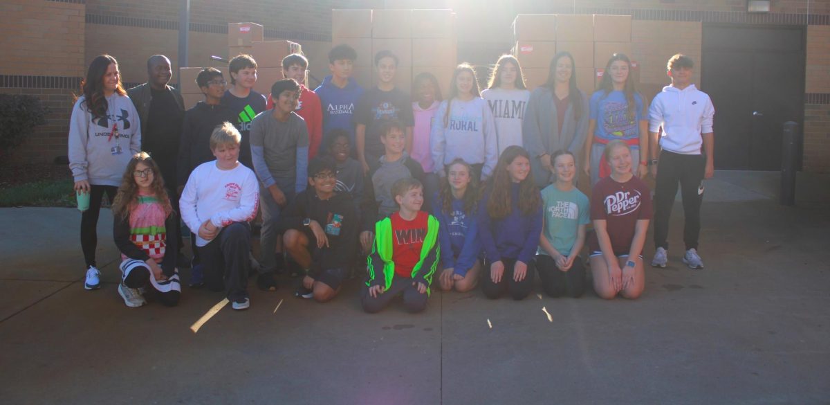 On November 6th, Mrs. Estenson’s class helps gather food boxes to get ready to be put inside the Harvesters truck.