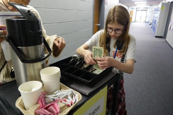 8th grader, Emma Gibson counts money in the hallway to give the correct amount of change on November 6th.
