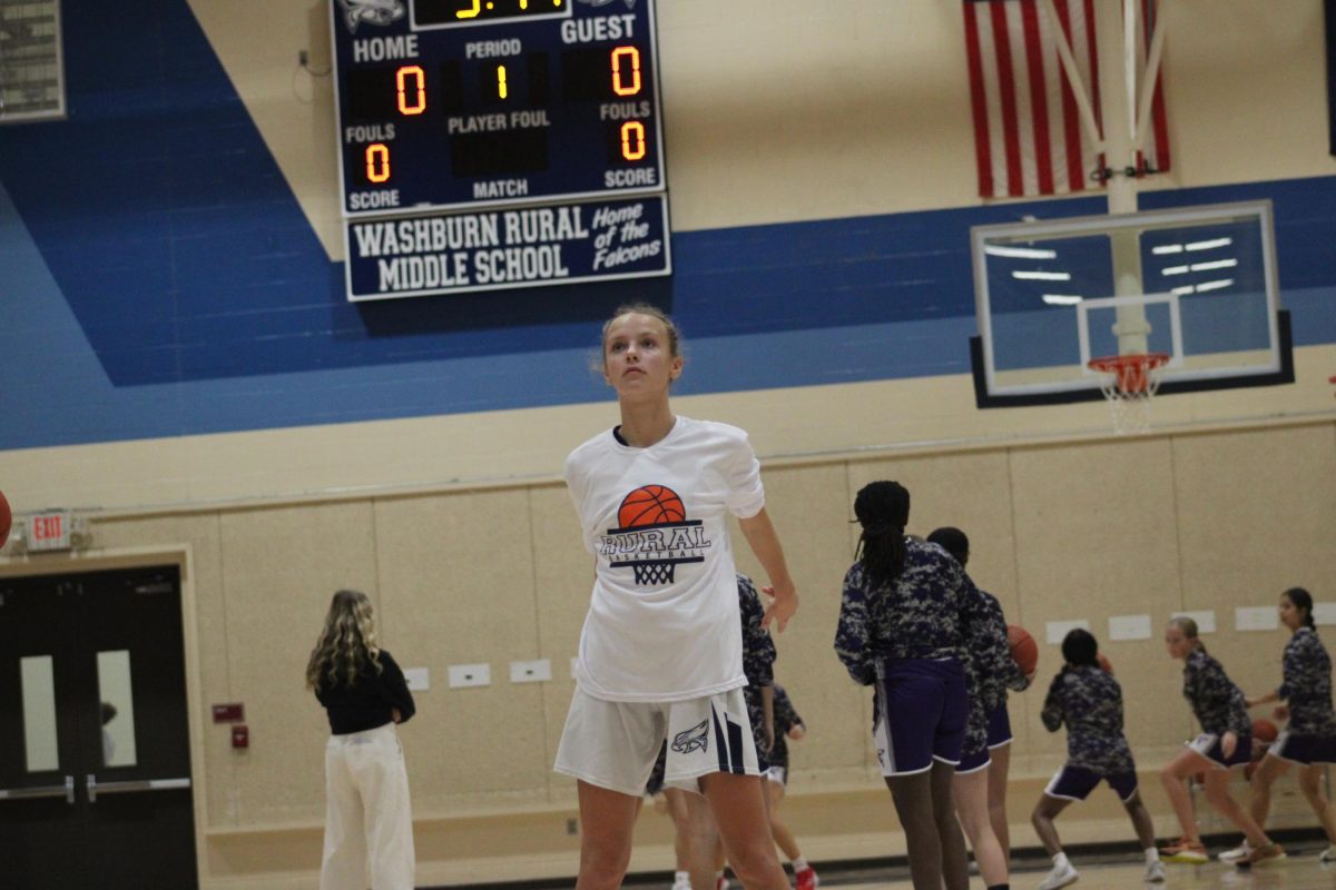 On Nov. 12, Morgan Munson warms up by shooting free throws before the basketball game against Susan B. Anthony at WRMS.