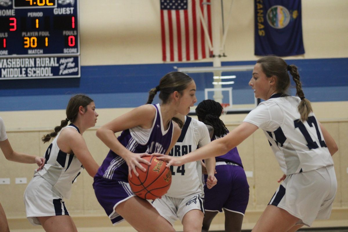 On Nov. 12, Eighth grader Bridget Hoopes makes a defensive effort to get the ball out of a Susan B. Anthony players hands at WRMS. 