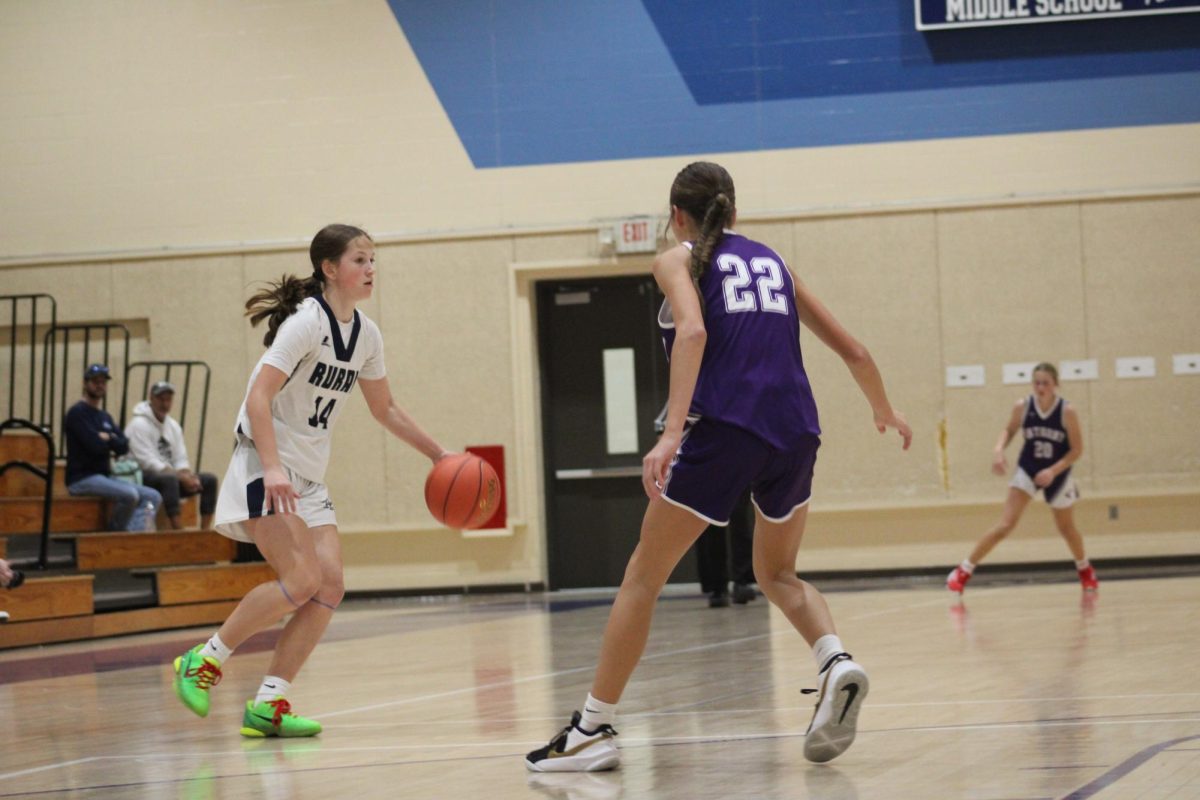 On Nov. 12, Kamryn Smith dribbles the ball down the court against Susan B. Anthony to make an offensive play at WRMS. Student athlete, Smith said she enjoys the friendships she’s made though the team. “My favorite part is the friendships and the good memories that we’ve had over the season”. 
