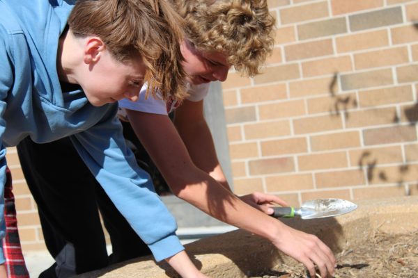 Isaiah Sexton and Cooper Strathman were planting flowers for the Green club.