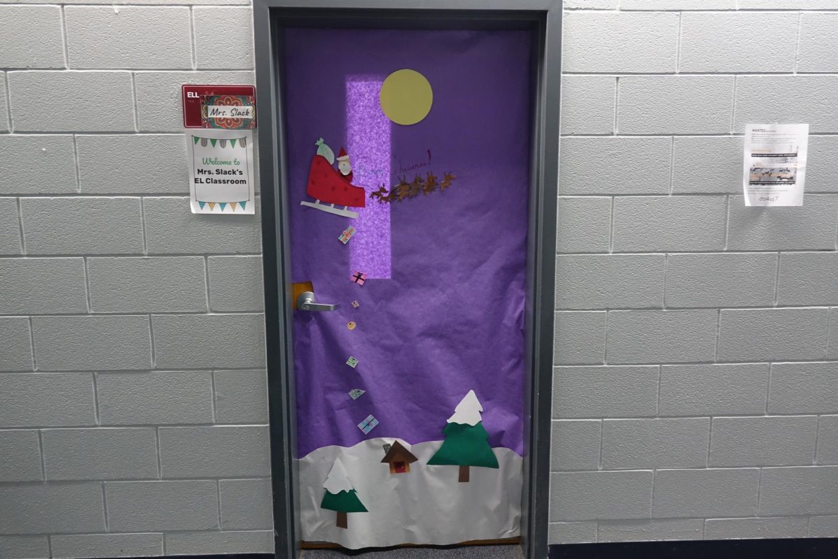 Stuco students decorate the copy room door during advisories in the seventh grade hallway for Christmas.
