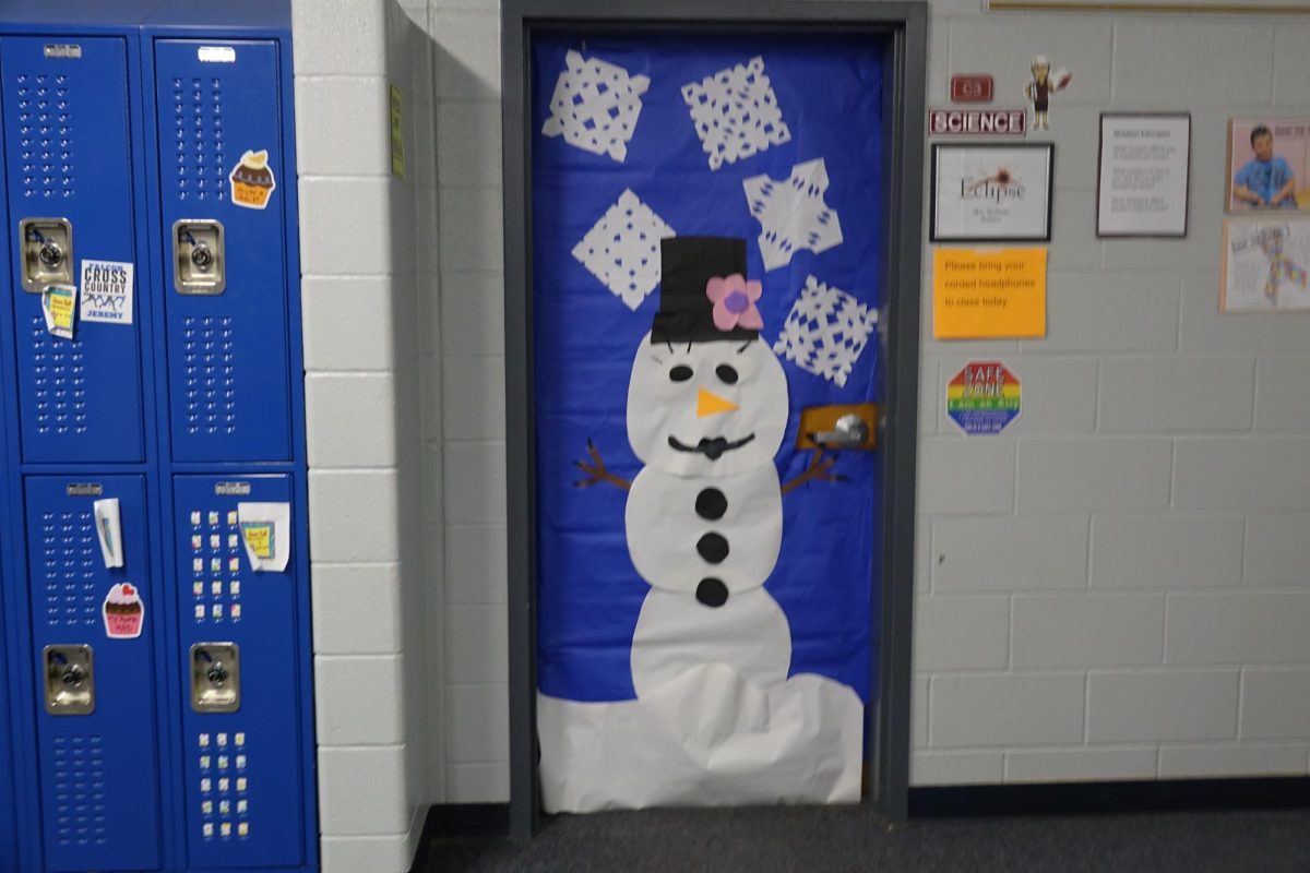 Ms. Wolfert’s students decorate her door as a snowman during advisory in the seventh grade hallway for the christmas door decorating competition. 
