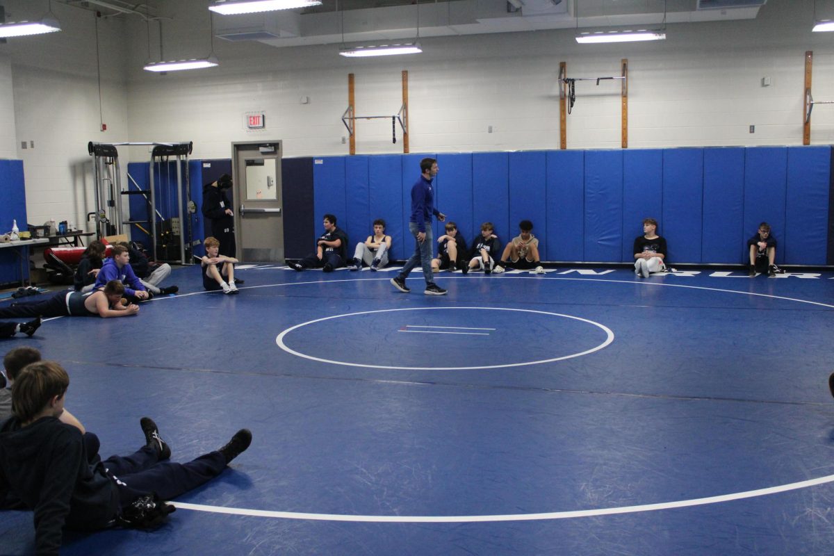 Coach Short gives a speech before the matches start on Nov. 18th, Short said“I started coaching wrestling to share my passion and knowledge for the sport with others. It allows me to impact people's lives in a positive way. As a coach, there's no better feeling than seeing your guys hand raised at the end of a match.” 