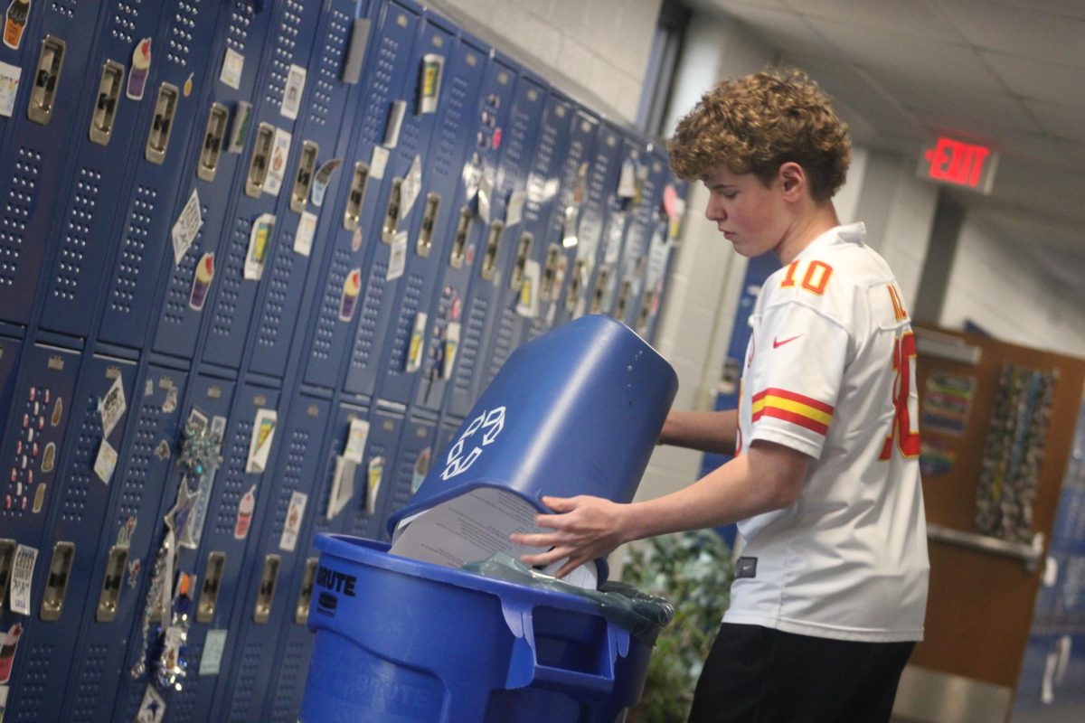 On Feb. 7, during advisory at WRMS, eighth grader Bo Loeffler recycles paper to contribute in Green Club.