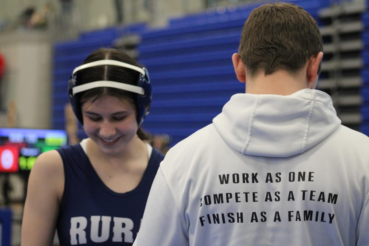 On February 8,  eighth grader Tiffany Schneider and Coach Short discuss her win at Junction City High School during a tournament. 