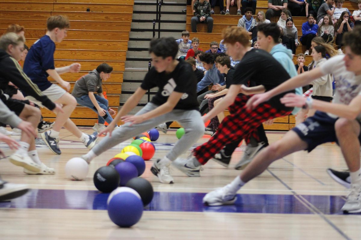 Eighth graders start a game of dodgeball by running towards mid court on Feb. 5 during FAST time as a reward of good behavior and grades. 