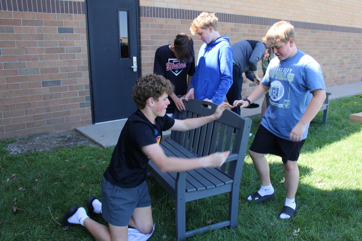 On April 4, eighth graders Bo Loeffler, Blake Loeffler, Cooper Strathman, and Riley Kaufman build a bench for Green Club during advisory outside the seventh grade pod to make a nice place for students. 
