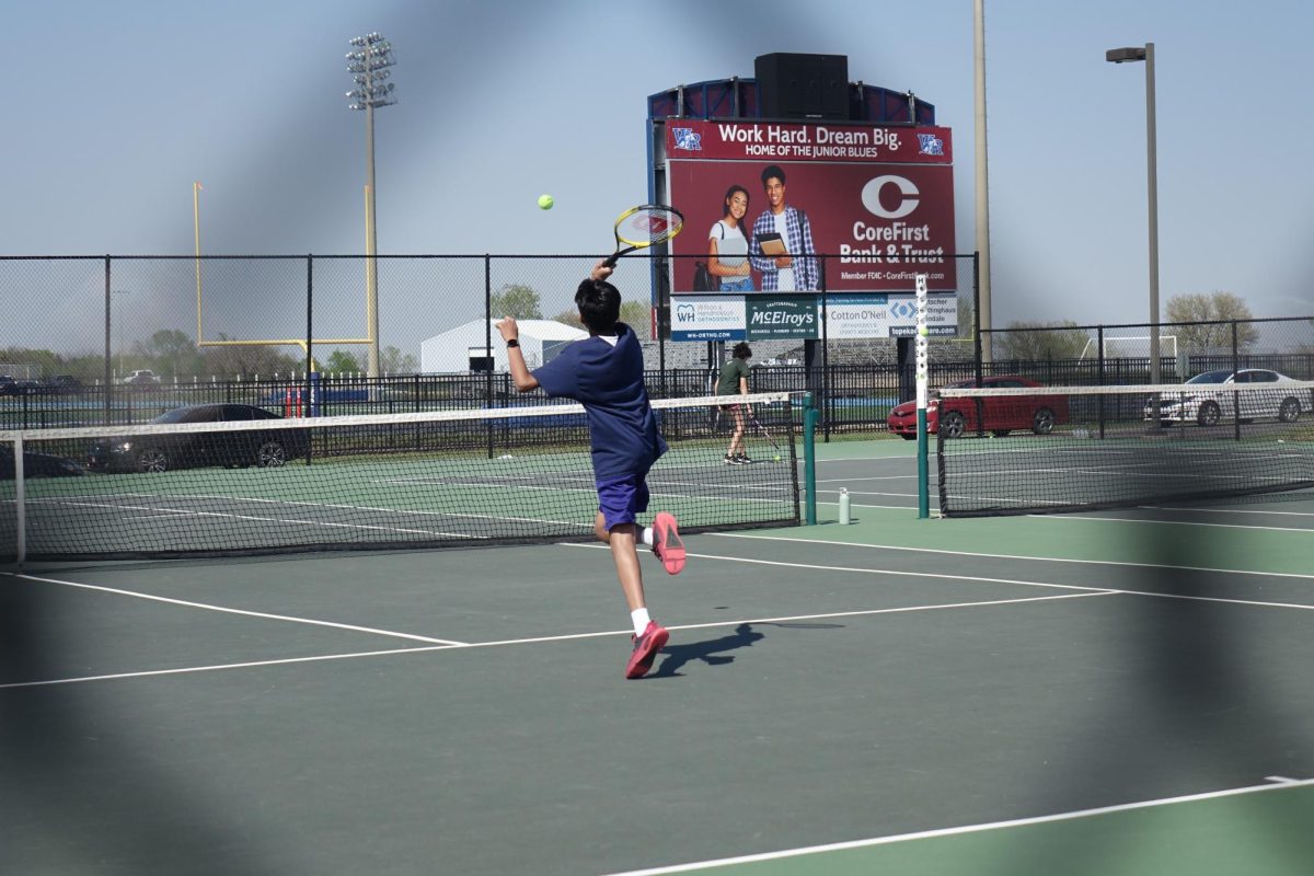 Seventh grader Parv Patel hits a volley to his opponent on April 15 in match against Eisenhower at WRHS.