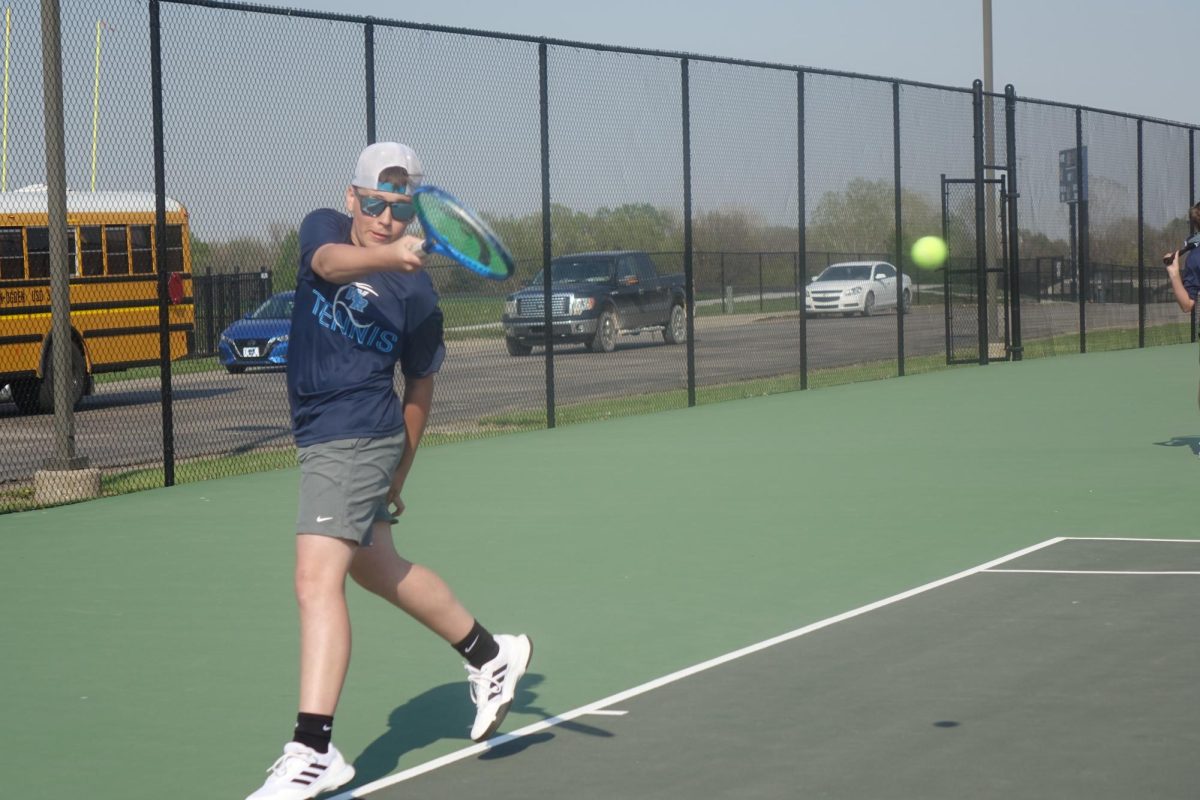 On April 15, seventh grader Ryder Andrews hits the ball to his opponent in a match against CPLS at the WRHS tennis courts.