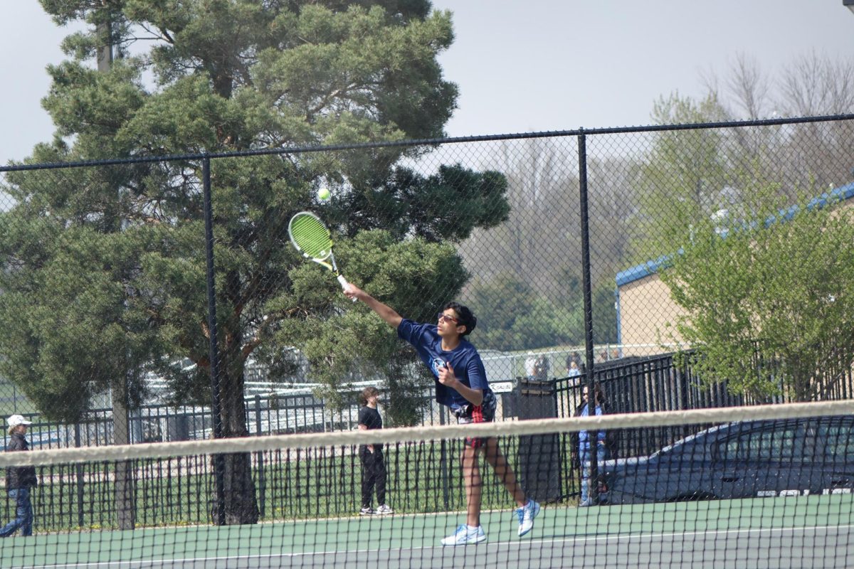 Eighth grader Akul Chamesh serves the ball to his opponent to get the point in a meet at WRHS on April 8.