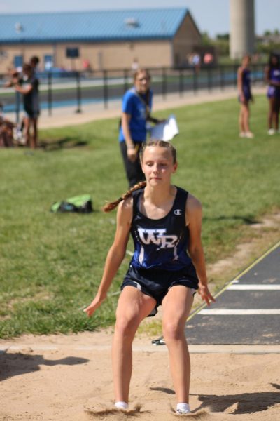 At a WRMS track meet eighth grader Morgan Munson does her triple jump to support her track team on may 5. “I do track because its a fun sport, I get to hangout with friends and also get a good workout.”she said.