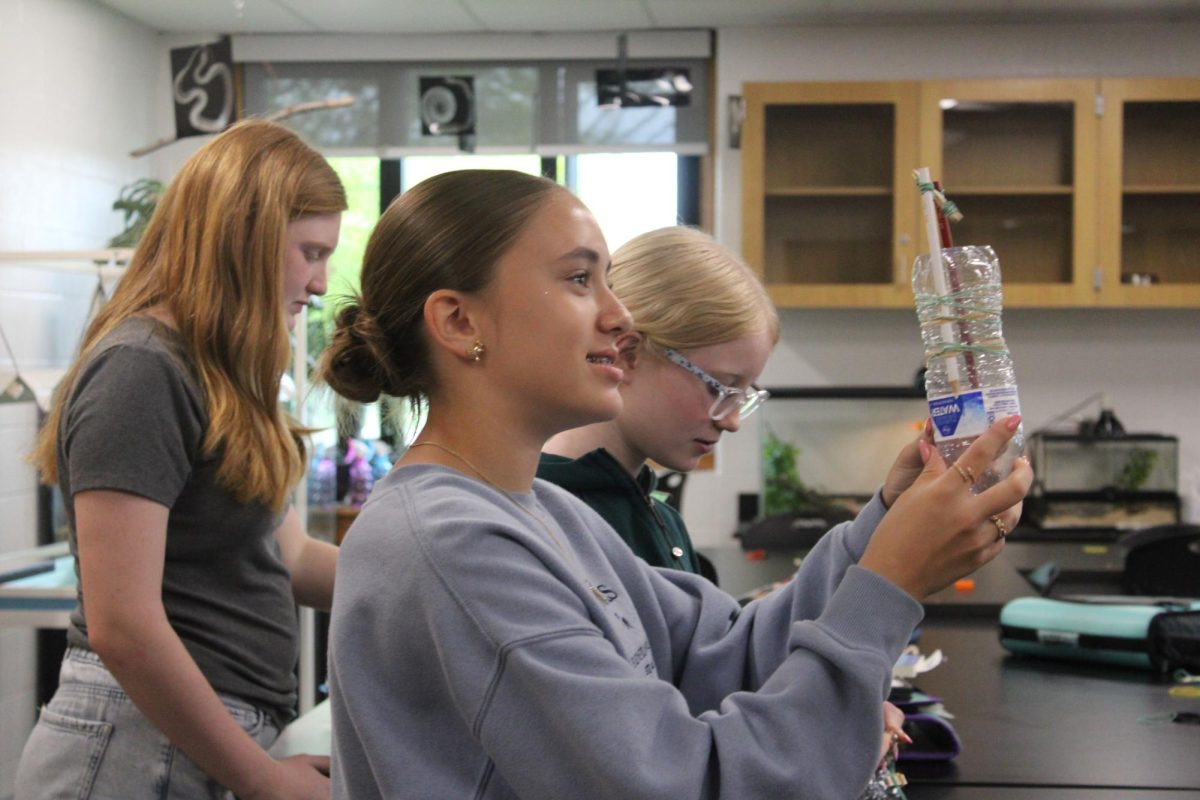 Seventh grader Sophia Heble shows Mrs. Roney her water bottle boat in 1st hour science on May 7th.

