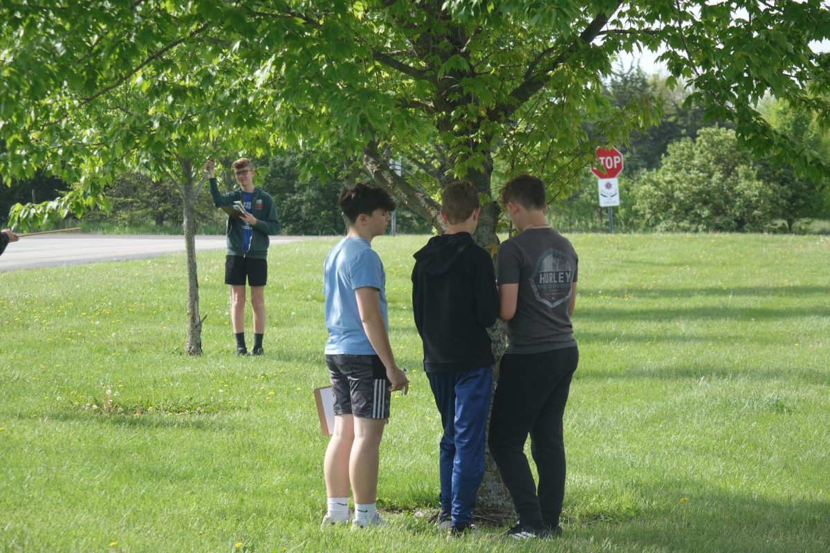 8th graders Cannon Haugsness, Roman Shields, Julius Wood-Nichols, and Jace Jackson on the Wave team examine trees for science on May 4th.
